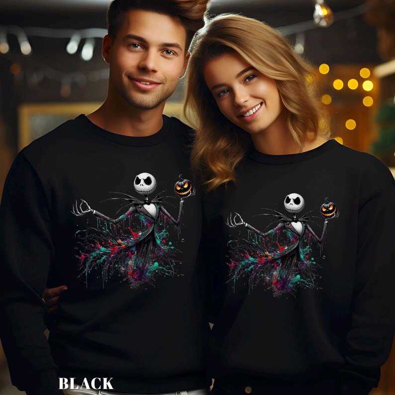 A man and a woman are standing together, both wearing black sweatshirts with a Jack Skellington character design.