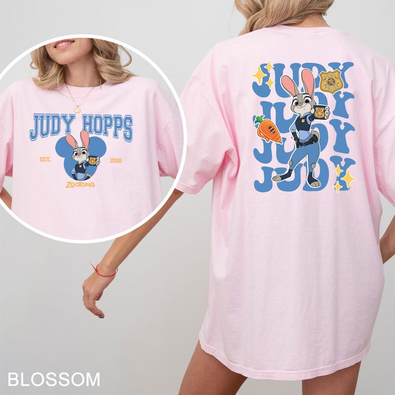 A woman wearing a pink t-shirt with a cartoon image of a police officer on the back.