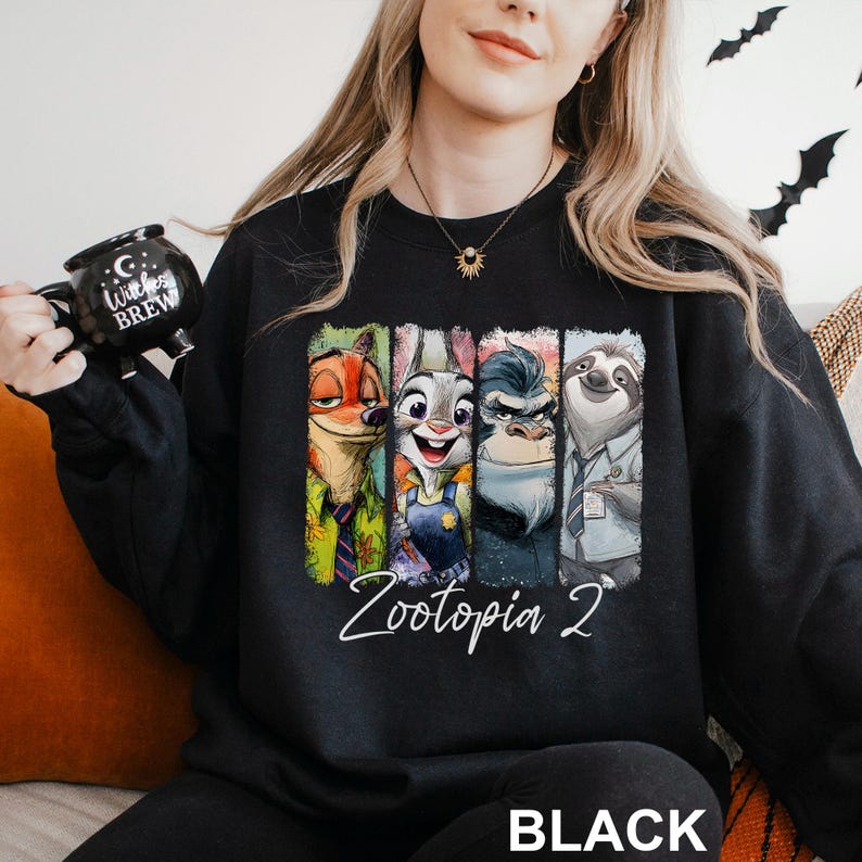 A woman wearing a black sweatshirt with a graphic of four cartoon animal characters from the movie "Zootopia" printed on it.