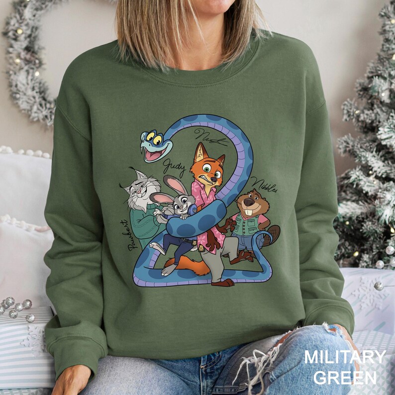 A woman wearing a green sweatshirt with a cartoon character design on it.
