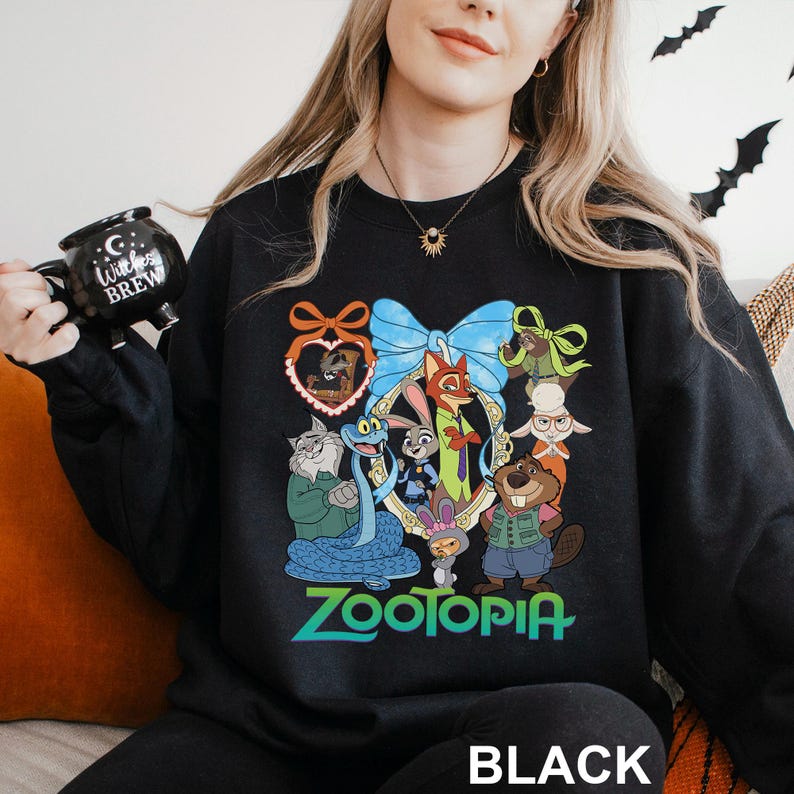 A woman wearing a black sweatshirt with a colorful graphic of cartoon animals and the word "Zootopia" printed on it.