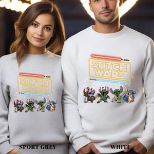 A man and a woman are standing next to each other, both wearing white sweatshirts with a Star Wars-themed design featuring characters from the Star Wars franchise.