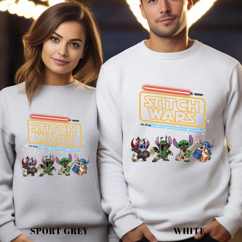 A man and a woman are standing next to each other, both wearing white sweatshirts with a Star Wars-themed design featuring characters from the Star Wars franchise.