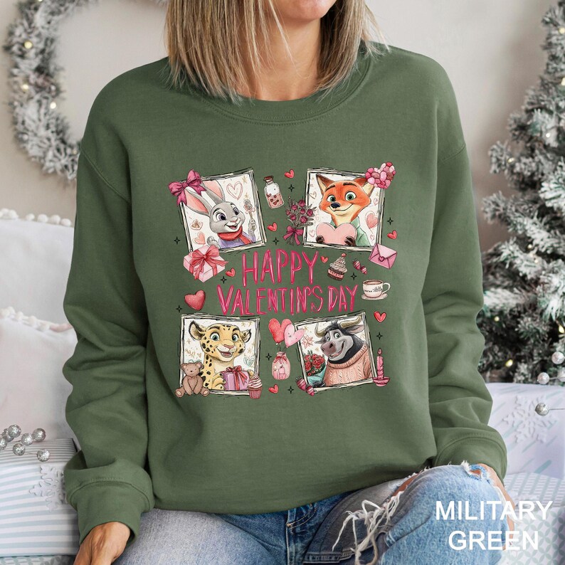 A woman wearing a green sweatshirt with a graphic design featuring cartoon animal characters and the text "Happy Valentine's Day".