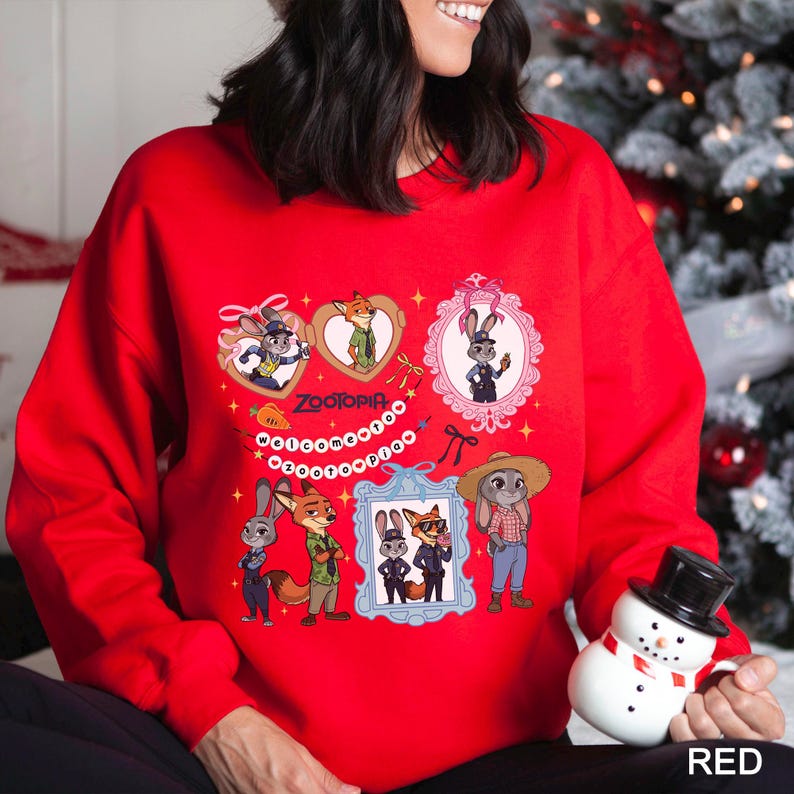 A woman wearing a red sweater with various cartoon animal characters on it, including a dog, cat, rabbit, and fox, along with a snowman and a Christmas tree in the background.