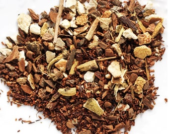May include: A close-up of a blend of loose leaf tea with red rooibos, orange peel, cinnamon sticks, licorice root, and other herbs.
