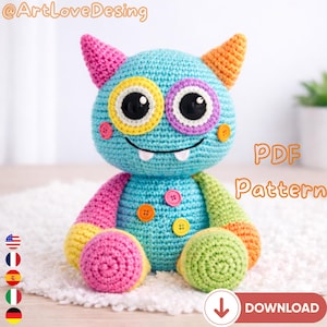 May include: A handmade crochet monster doll in shades of blue, pink, yellow, and green. The monster has large, colorful eyes, small horns, and a smiling mouth. The text "PDF Pattern" is visible.