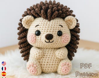 May include: A crocheted hedgehog with a light brown body, dark brown spines, and pink cheeks and paws. The hedgehog has black eyes and a brown nose. The image includes the text "PDF Pattern" and a download icon.