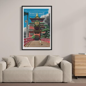 May include: A black framed poster with a colorful illustration of a building with a red bridge leading to it. The poster has the text "Spirited Away" in white letters on a black background.