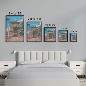 May include: A comparison of different sizes of a framed print of the Spirited Away movie poster. The poster features a colorful illustration of a Japanese-style building with a red bridge in front of it. The poster is framed in black.