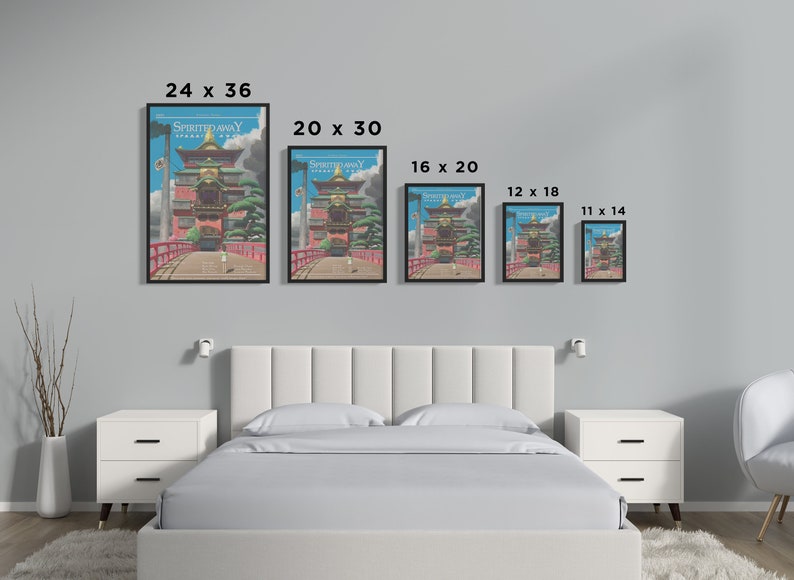 May include: A comparison of different sizes of a framed print of the Spirited Away movie poster. The poster features a colorful illustration of a Japanese-style building with a red bridge in front of it. The poster is framed in black.