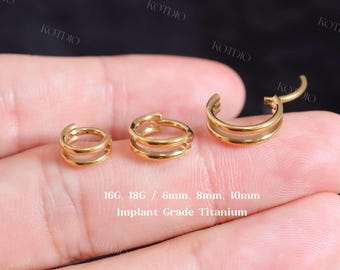 May include: Three gold-colored, double-hoop earrings of varying sizes are displayed. The earrings are made of Implant Grade Titanium. Sizes include 6mm, 8mm, and 10mm.