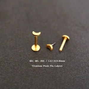 May include: Gold titanium push pin labret with a crescent moon top. Available in 16G, 18G, and 20G sizes, and 5.6 to 10mm lengths.
