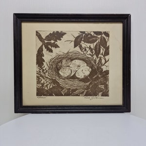 May include: A framed black and white print of a bird's nest with eggs. The print is signed "Ruth Bechlerman" and titled "Hemlock".