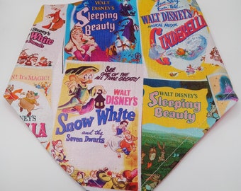 May include: A colorful fabric featuring vintage movie posters for Disney classics like Snow White and the Seven Dwarfs, Cinderella, and Sleeping Beauty. The posters are in a variety of colors, including red, yellow, blue, and green.