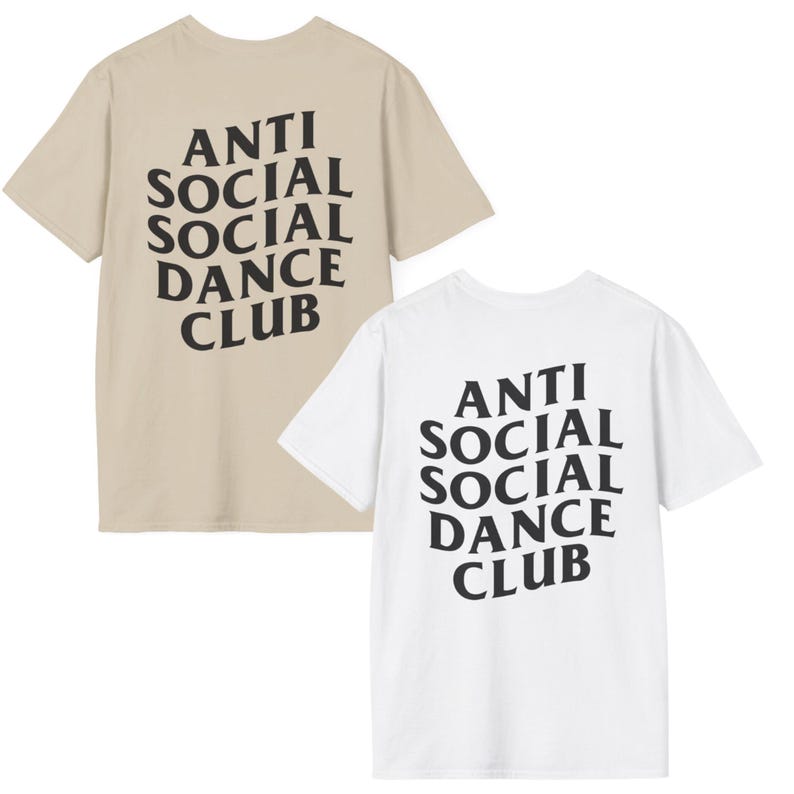 May include: Two t-shirts, one beige and one white, each with the text "ANTI SOCIAL SOCIAL DANCE CLUB" printed in black. The text is in a bold, stylized font.