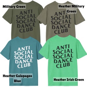 May include: Four t-shirts in military green, heather military green, heather Galapagos blue, and heather Irish green. Each shirt features the text "ANTI SOCIAL SOCIAL DANCE CLUB" in a bold, stylized font. The shirts are short-sleeved and have a crew neck.