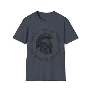May include: A dark blue t-shirt with a black graphic of a Roman helmet and the text "Probably thinking about the Roman Empire".