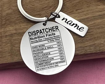 May include: Silver keychain with a round tag that reads "DISPATCHER Nutrition Facts Serving Size: 1 Essential Worker % Daily Value* HARD WORK 100% INCREDIBLE SKILL 100% PASSION 100% INTELLIGENCE 100% DEDICATION 100% DETERMINATION 100% COMMITMENT 100% DAILY VALUE MAY BE HIGHER OR LOWER DEPENDING ON THE NEEDS OF THE PEOPLE I SERVE" and a smaller tag that reads "name".