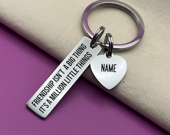May include: Silver keyring with a rectangular tag that reads "Friendship isn't a big thing it's a million little things" and a heart-shaped tag that says "NAME".