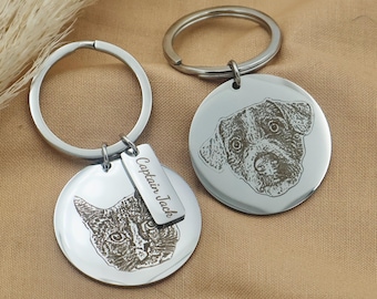 May include: Two silver keychains with engraved images of a cat and a dog. The keychain with the cat has a tag that reads "Captain Jack".