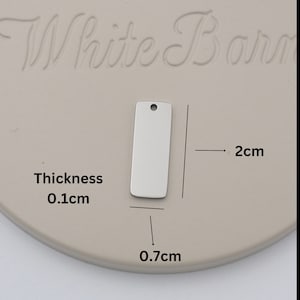 a white board with a tag attached to it