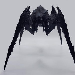 May include: A black, stylized sculpture of a spider with sharp, pointed legs and a textured body. The arachnid figure has a menacing appearance, with a detailed exoskeleton and a central body section. The sculpture is set against a plain white background.