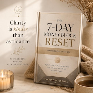 May include: A hardback book, "The 7-Day Money Block Reset", with gold text on a beige cover. The image also shows a lit candle, a cup of tea, and the text "Clarity is kinder than avoidance."