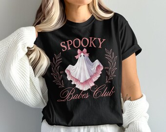 May include: Black t-shirt featuring a pink ghost wearing a pink bow and the text "Spooky Babes Club" with the text "Est. 1993" below the ghost.