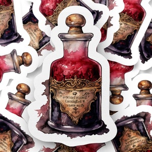 May include: A die-cut sticker featuring a glass apothecary bottle filled with a deep red liquid. The bottle has a gold-toned ornate label with illegible text and a rounded stopper. The design includes watercolour-style dark purple and red ink splatters.
