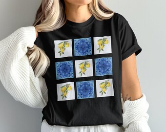 May include: Black t-shirt with a pattern of blue and white tiles with lemons on a branch.