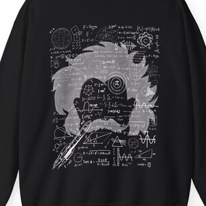 May include: Black sweatshirt featuring a white graphic of a scientist's silhouette with equations and formulas. The design includes a rocket, the pi symbol, and the text "E=mc²". A unique and educational apparel item.