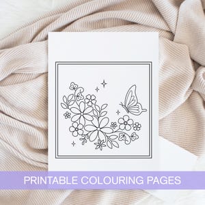 May include: A black and white printable coloring page featuring a butterfly and a floral design. The design includes a cluster of flowers and leaves with a butterfly flying above them.
