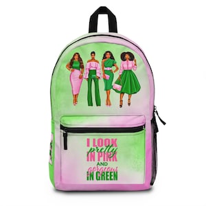 May include: A green and pink backpack with a design of four women in different outfits. The backpack has a zippered pocket and the text "I look pretty in pink and gorgeous in green".