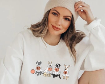 May include: White sweatshirt with a graphic of four dogs dressed as ghosts holding pumpkins. The dogs are a black lab, a golden retriever, a black lab, and a brown and white dog.