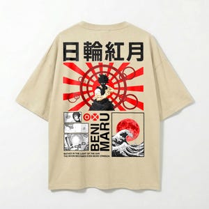 May include: Beige t-shirt with a Japanese-inspired graphic. The design features red and black text, a rising sun, and a manga-style illustration of a person and a wave with a red moon. The text reads "BENI MARU".