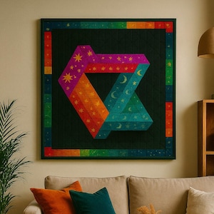 May include: A large, framed quilt with a geometric design in shades of pink, orange, teal, and green, featuring stars and crescent moons. The quilt hangs above a beige sofa with orange and teal throw pillows. A wooden coffee table and a potted plant are in the foreground.