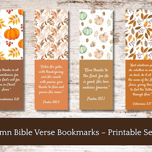 May include: Set of four autumn-themed Bible verse bookmarks. Each bookmark features a different design with fall elements like pumpkins and leaves, paired with a scripture quote. The bottom section of each bookmark is a solid brown color.