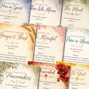 May include: A collection of inspirational cards with watercolor backgrounds and elegant calligraphy. Each card features a different biblical verse, such as "Blessed are the Poor in Spirit" and "Blessed are the Peacemakers." The cards have floral and wheat accents.