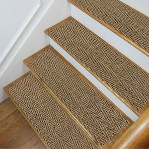 May include: Brown stair treads with a textured herringbone pattern. The treads are made of a soft, non-slip material and are designed to add a touch of style and safety to any staircase.
