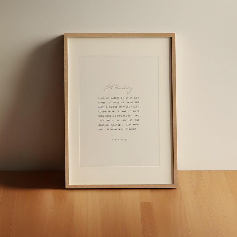 May include: Framed print with a light wood frame. The print features the words "All thinking" in cursive at the top, followed by a quote from C.S. Lewis in a simple, elegant font. The background is off-white.