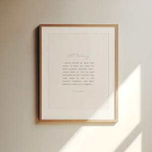 May include: A framed print with a light wood frame. The print features the words "All thinking" in cursive at the top, followed by a quote from C.S. Lewis in a simple, elegant font. The background is a soft, off-white color.