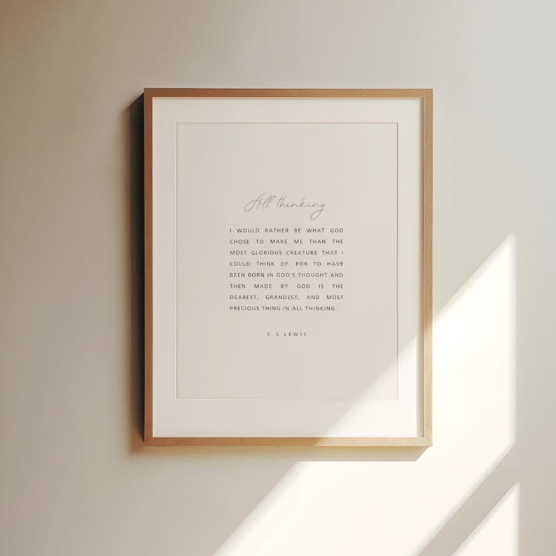 May include: A framed print with a light wood frame. The print features the words "All thinking" in cursive at the top, followed by a quote from C.S. Lewis in a simple, elegant font. The background is a soft, off-white color.