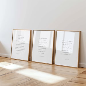 May include: Three framed prints with inspirational quotes in black text on a white background. The frames are a light brown color. The prints are leaning against a white wall on a wooden floor.
