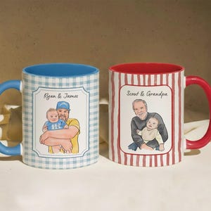 May include: Two ceramic mugs featuring custom illustrations. The left mug has a blue gingham pattern, a blue handle, and an illustration of Ryan and James. The right mug has a red striped pattern, a red handle, and an illustration of Scout and Grandpa.