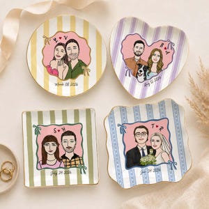 May include: Four ceramic trinket dishes with gold rims, each featuring a custom illustration of a couple. The round dish has yellow stripes, the heart-shaped dish has purple stripes, the square dish has green stripes, and the wavy dish has blue stripes.