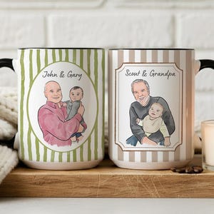 May include: Two ceramic mugs with black handles. The left mug has green stripes and a circular illustration of two people with the text John & Gary. The right mug has beige stripes and a rectangular illustration of two people with the text Scout & Grandpa.