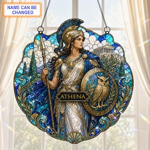 May include: A circular stained glass suncatcher featuring Athena in a helmet and armor, holding a spear and a shield with an owl. The design includes a temple in the background, blue and gold tones, and a central plaque with the text ATHENA.