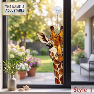 May include: A stained glass giraffe suncatcher with brown and amber geometric patterns, featuring the name BENNY on its forehead. It hangs from a suction cup with a silver chain. A text box in the corner states THE NAME IS ADJUSTABLE.