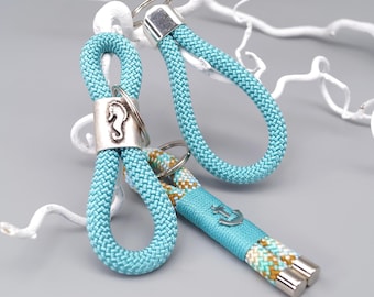 May include: Three nautical-themed keychains. Two are made of turquoise rope with silver accents, one featuring a seahorse charm. The third keychain has an anchor charm and a section of rope in turquoise, tan, and white.